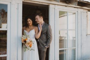 Featuring our Lacy Dress against a rustic wedding venue.